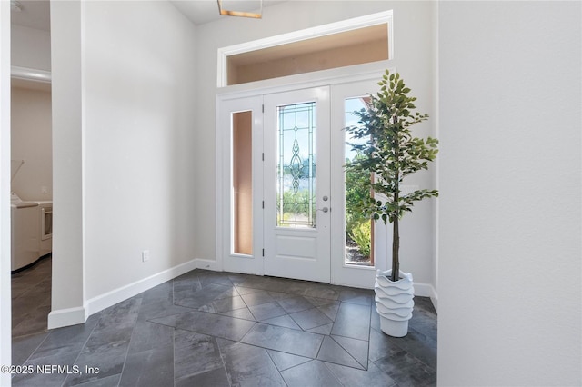 foyer entrance with washer / dryer and a wealth of natural light