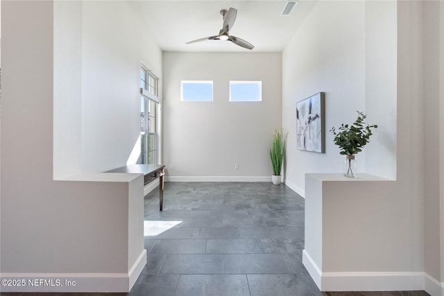 foyer entrance with ceiling fan