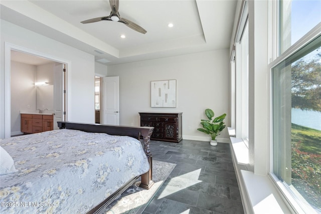 bedroom with a tray ceiling and ceiling fan