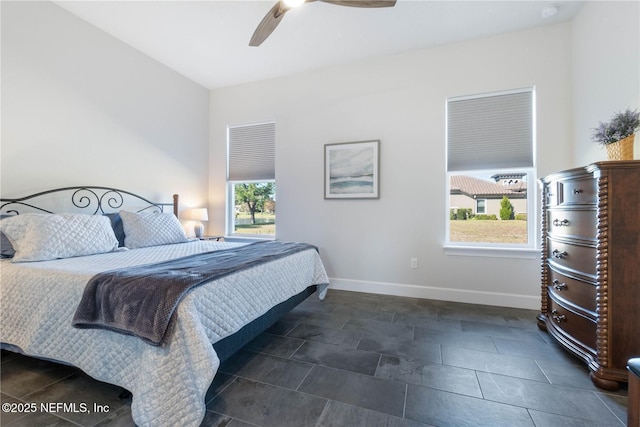 bedroom with ceiling fan and multiple windows