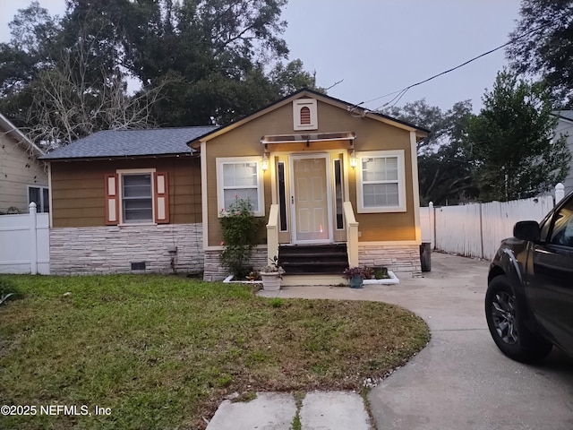 bungalow-style house featuring a front lawn