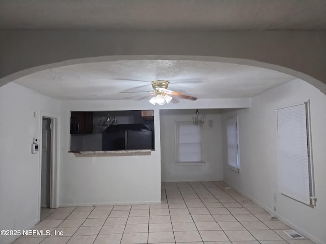 spare room with ceiling fan and light tile patterned flooring