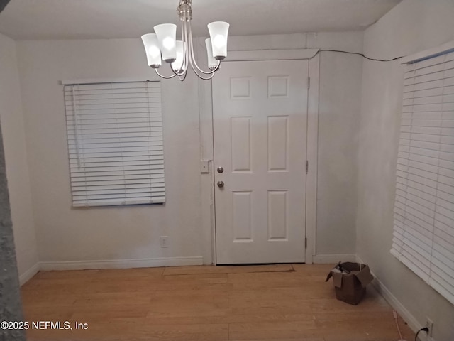 interior space with light hardwood / wood-style flooring and a chandelier