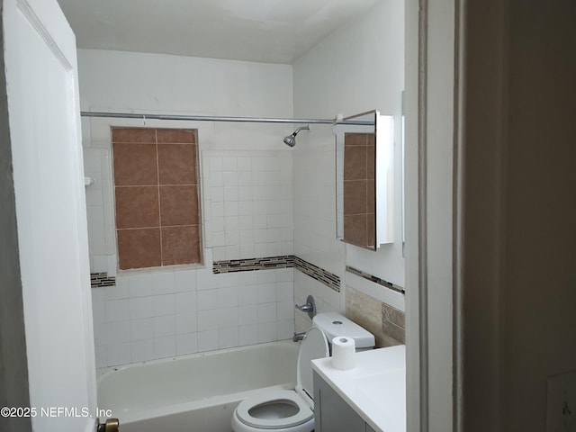 full bathroom featuring vanity, toilet, and tiled shower / bath