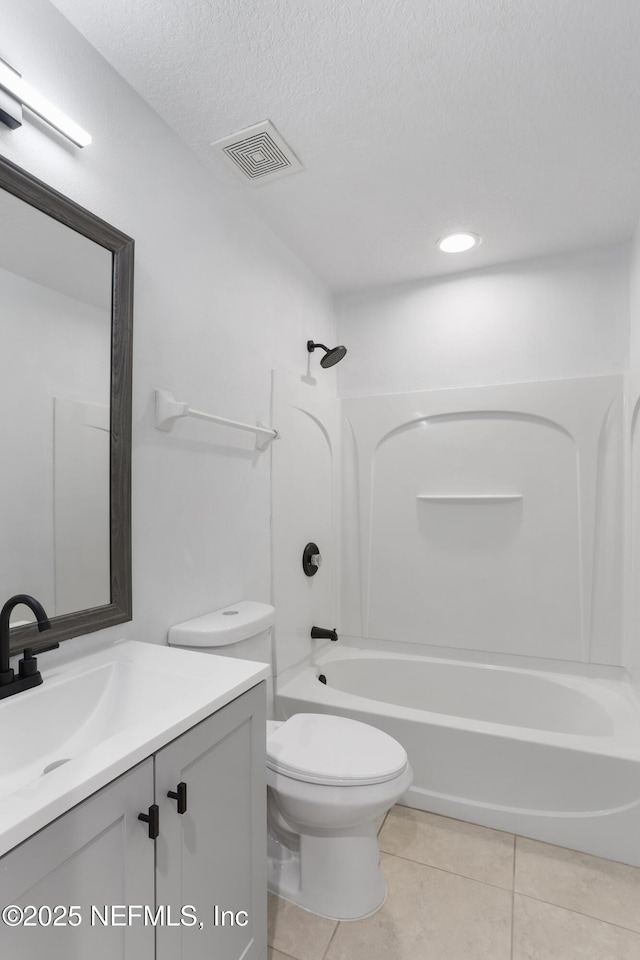 full bathroom with tile patterned floors, vanity, a textured ceiling, bathing tub / shower combination, and toilet