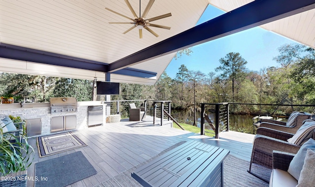 wooden deck featuring exterior kitchen, ceiling fan, and a grill