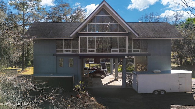 rear view of house featuring a sunroom