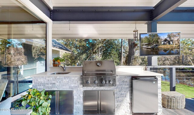 view of patio featuring area for grilling, an outdoor kitchen, and sink