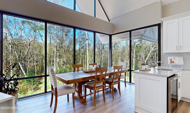 sunroom / solarium featuring sink, wooden ceiling, and lofted ceiling