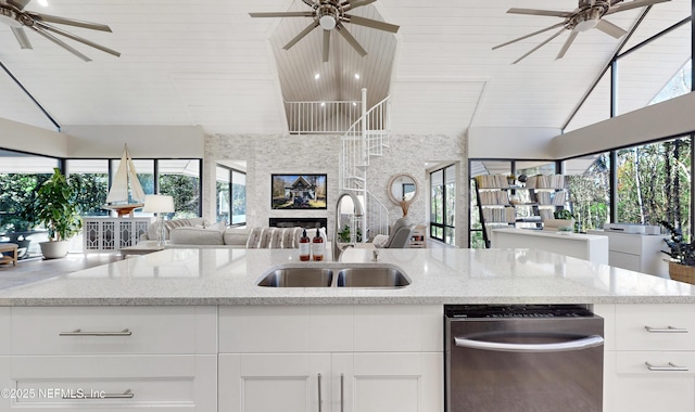 kitchen featuring light stone counters, dishwasher, white cabinets, wooden ceiling, and sink