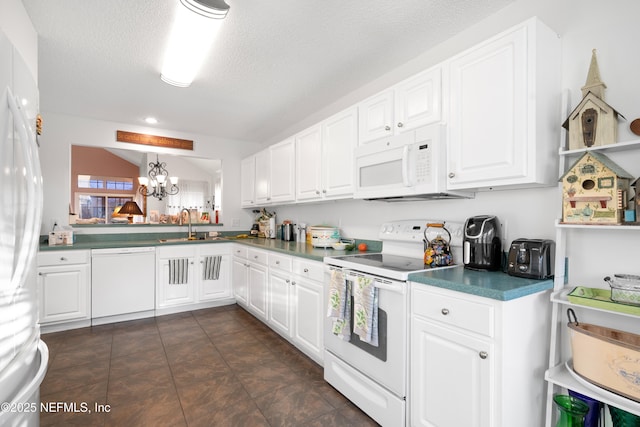 kitchen with white appliances and white cabinetry