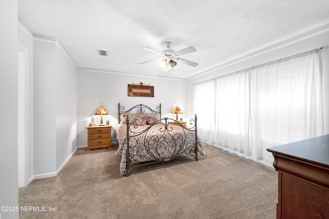 bedroom with carpet, a textured ceiling, and ceiling fan