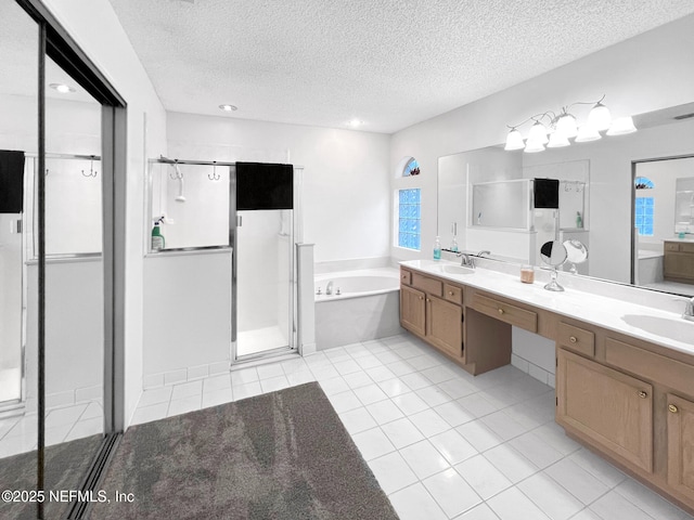 bathroom featuring vanity, tile patterned flooring, plus walk in shower, and a textured ceiling