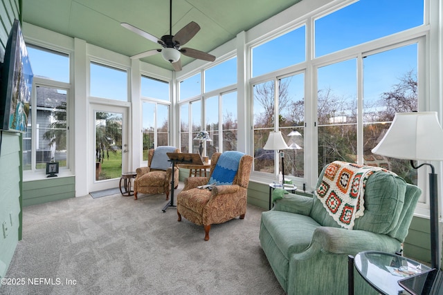 sunroom / solarium featuring plenty of natural light and ceiling fan