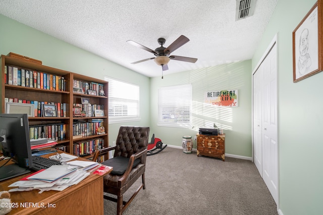 office area with carpet flooring, ceiling fan, and a textured ceiling