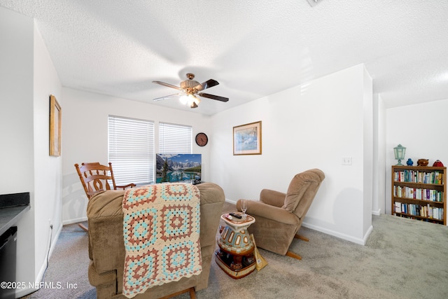 interior space featuring a textured ceiling, light colored carpet, and ceiling fan