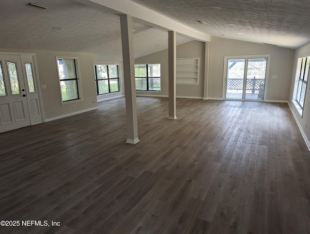 unfurnished living room featuring a textured ceiling, lofted ceiling, dark hardwood / wood-style flooring, and built in features