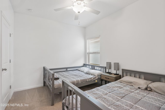 bedroom featuring baseboards, a ceiling fan, and light colored carpet