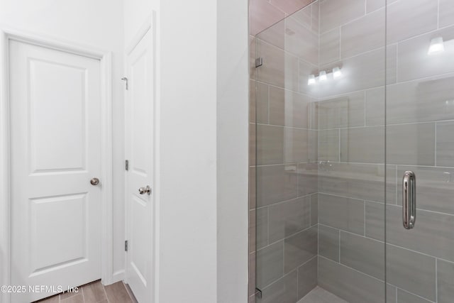 bathroom featuring a shower with door