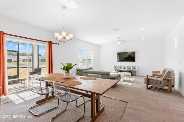 dining space featuring ceiling fan with notable chandelier, recessed lighting, baseboards, and light wood-style floors