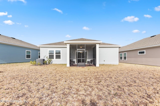 back of property featuring a yard, cooling unit, and a sunroom