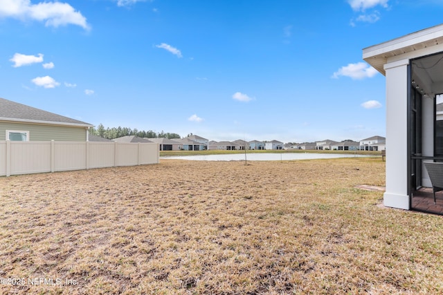 view of yard featuring a residential view and fence