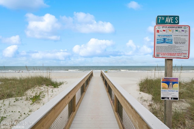 view of property's community with a view of the beach and a water view