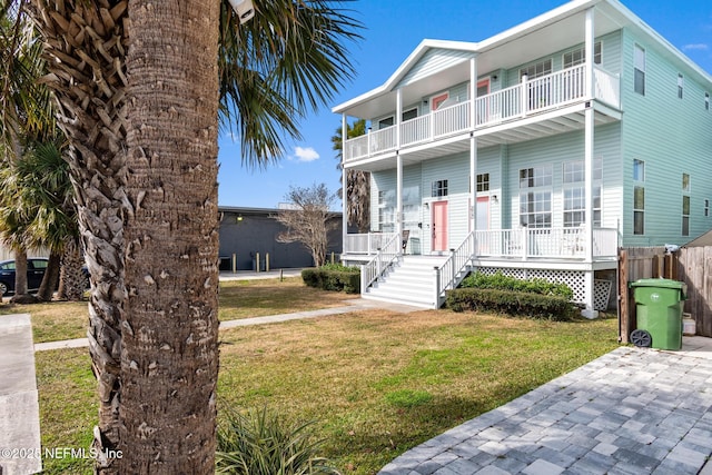 view of front of property with a front yard and a balcony