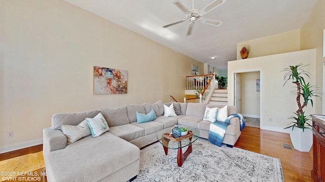 living room featuring lofted ceiling, light hardwood / wood-style flooring, and ceiling fan