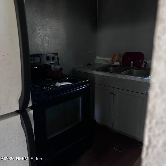 kitchen with black electric range and sink