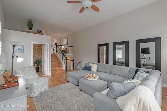 living room featuring ceiling fan and light hardwood / wood-style floors