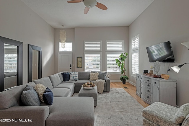 living room with ceiling fan and light wood-type flooring