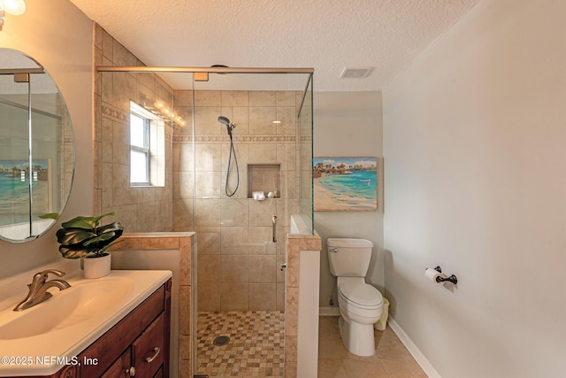 bathroom featuring a shower with door, vanity, a textured ceiling, tile patterned floors, and toilet