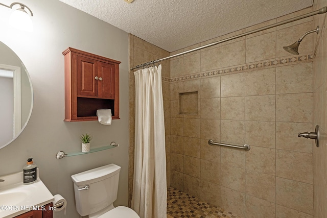 bathroom with a shower with curtain, vanity, a textured ceiling, and toilet