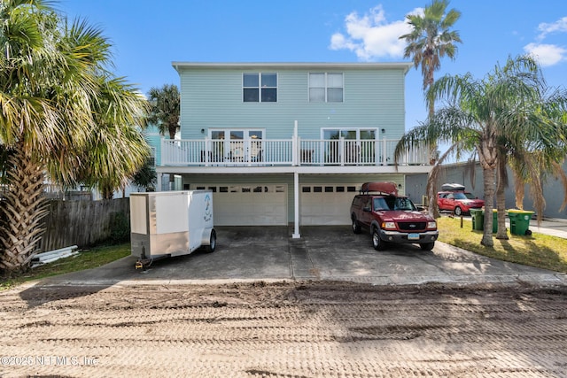 back of property featuring a garage and a balcony