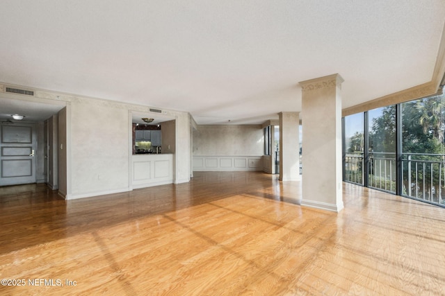 interior space featuring light wood-type flooring and a wall of windows