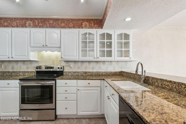 kitchen featuring white cabinetry, stainless steel electric range oven, sink, and dark stone counters