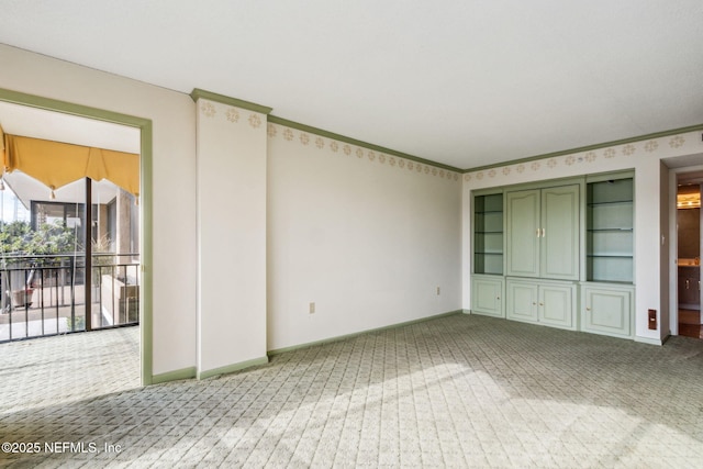 unfurnished living room with crown molding and carpet