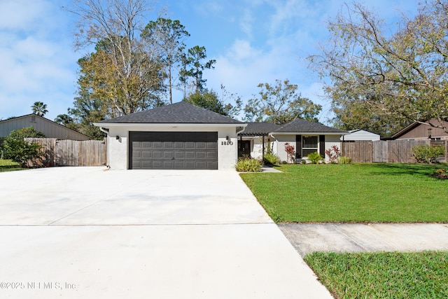 ranch-style house with a garage and a front lawn