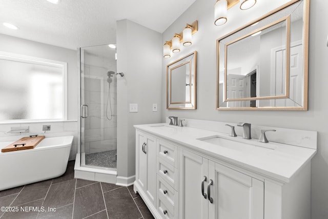 bathroom with vanity, a textured ceiling, tile patterned floors, and independent shower and bath