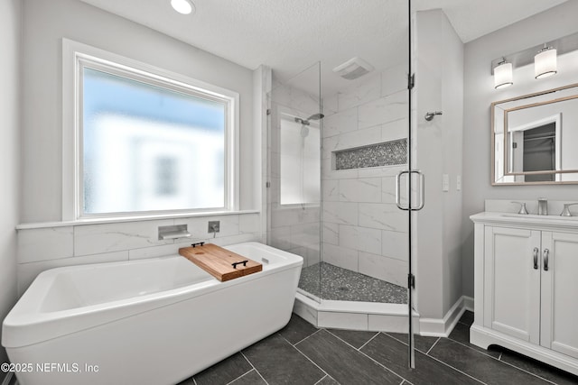 bathroom with tile patterned flooring, a textured ceiling, vanity, and separate shower and tub