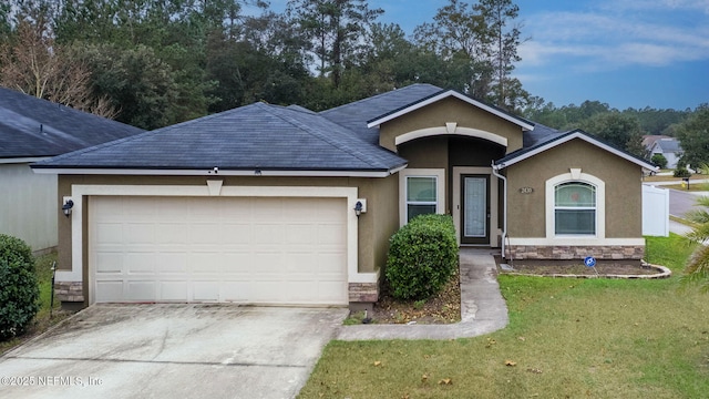 ranch-style home with a front yard and a garage