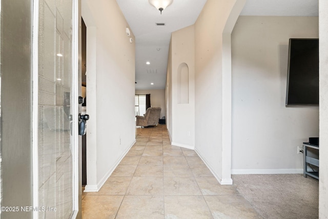 corridor featuring light tile patterned floors