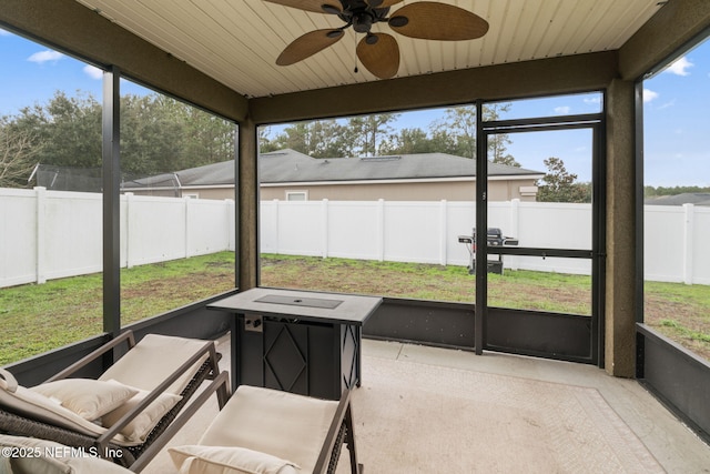 sunroom / solarium featuring ceiling fan