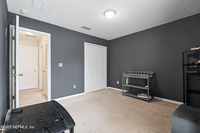 miscellaneous room featuring carpet floors and a textured ceiling