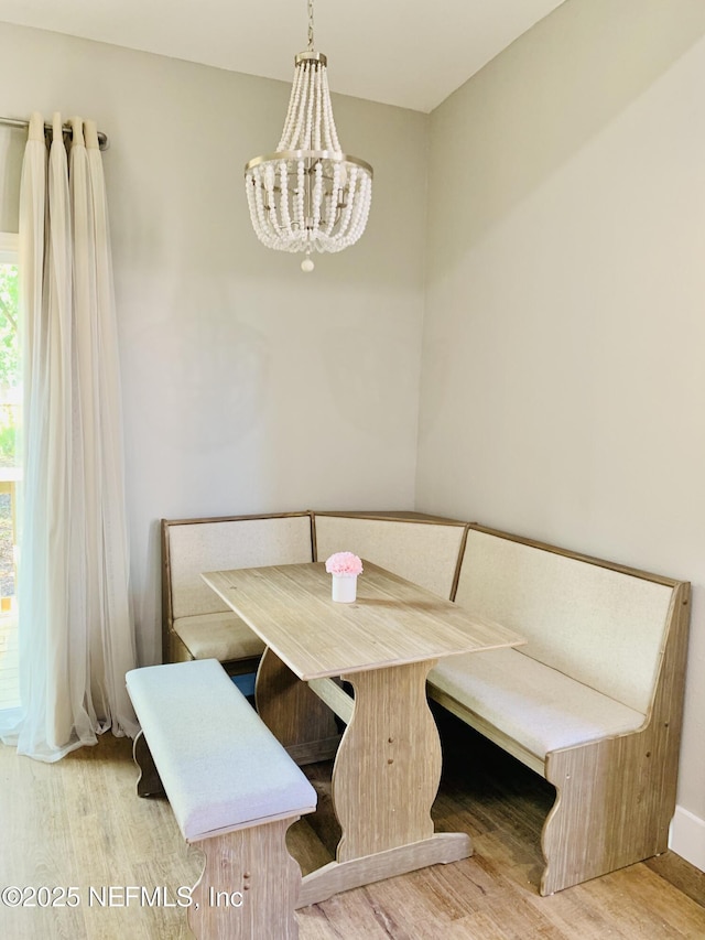 dining space with a chandelier and wood-type flooring