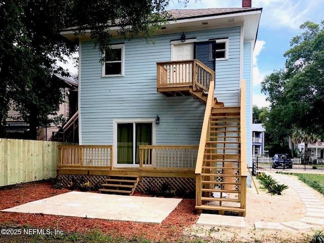 rear view of house with a patio and a deck