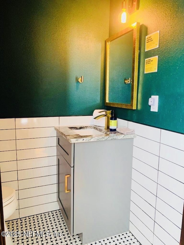 bathroom featuring tile patterned flooring, vanity, and toilet