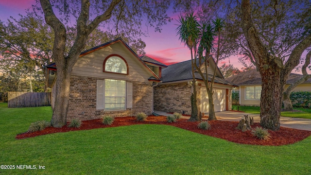 view of front of home with a yard and a garage