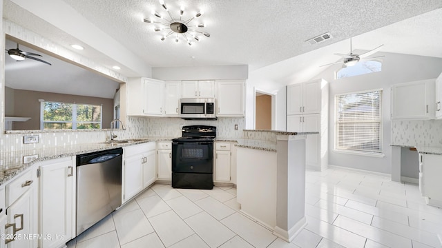 kitchen with kitchen peninsula, white cabinetry, lofted ceiling, and appliances with stainless steel finishes